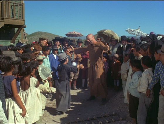 El Topo, reborn as a beggar, entertains the crowd with his companion, "The Small Woman" (Jacqueline Luis).