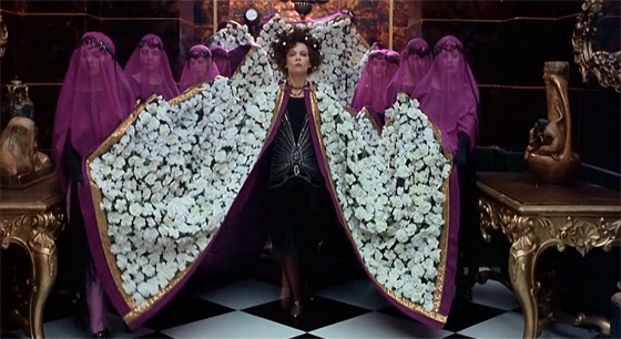 "Every day is Halloween in Tinseltown": Alla Nazimova (Leslie Caron) arrives at Valentino's funeral with style.