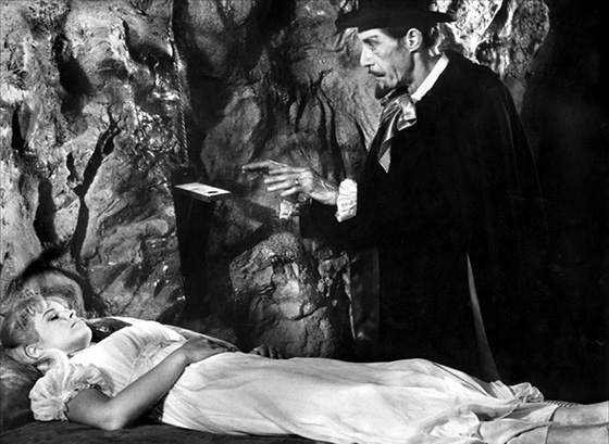 The vampire (John Carradine) mesmerizes Betty Bentley (Melinda Plowman) in an abandoned mine.