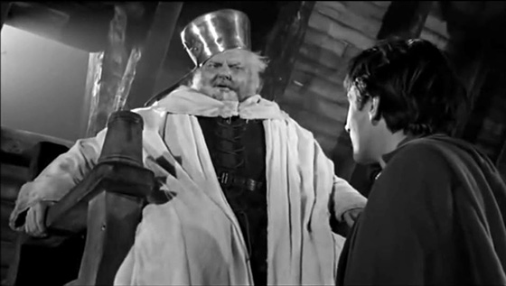 Falstaff (Orson Welles) impersonates the King for the amusement of Prince Hal (Keith Baxter).