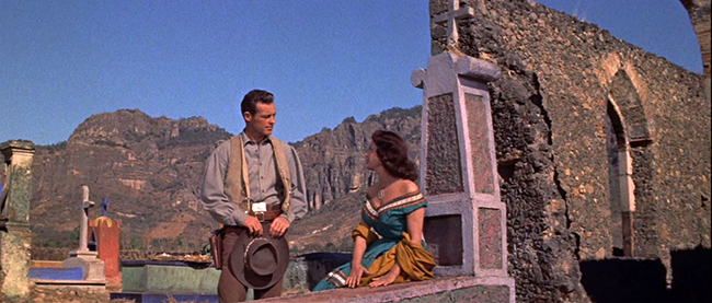 "The Beast of Hollow Mountain": Jimmy (Guy Madison) has a liaison with the lovely Sarita (Patricia Medina) in a Mexican graveyard.