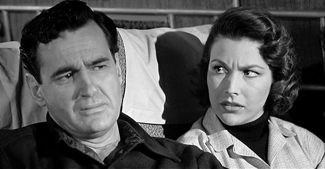 Mitch MacAfee (Jeff Morrow) and Sally Caldwell (Mara Corday) ponder the threat of The Giant Claw.