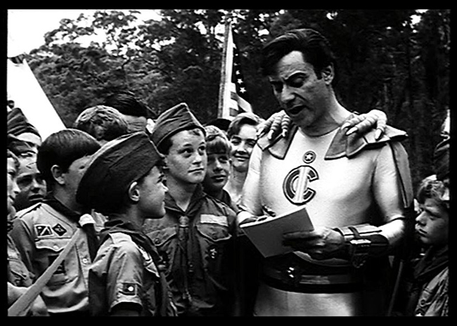 Captain Invincible (Alan Arkin) visits some boy scouts in the newsreel prologue.