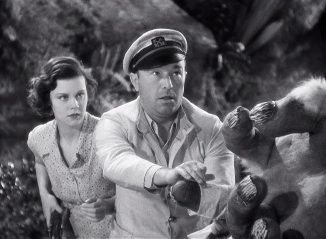 Carl Denham (Robert Armstrong) and Hilda (Helen Mack) delicately inform the Son of Kong about the death of his father.