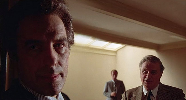 Ben Childress (John Cassavetes) meets with Dr. McKeever (Charles Durning).