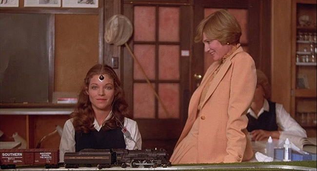 Gillian (Amy Irving) tests her psychic abilities on a model train.